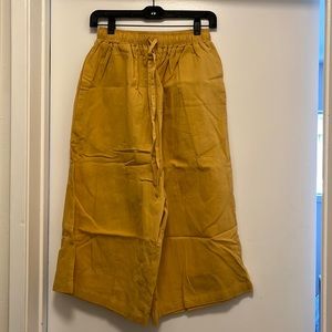 Light turmeric colored drop crotch wide leg pants
